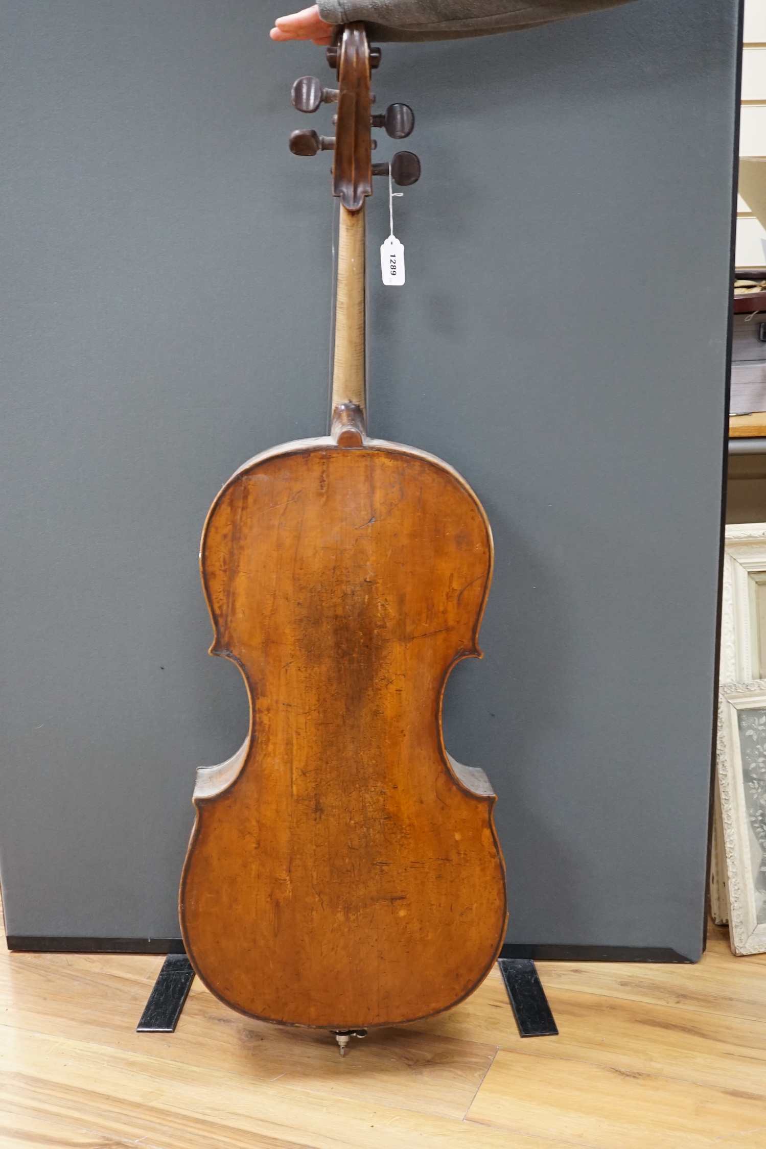 An early 20th century cello for restoration, indistinct internal label; ‘Restored by William J. Acton, Green Street, Forest Gate, London 1910’ length of body 72cm.